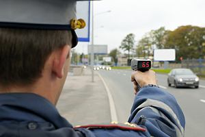 Cop checking cars for speeding 