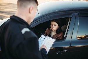 Cop issuing driver traffic tickets 