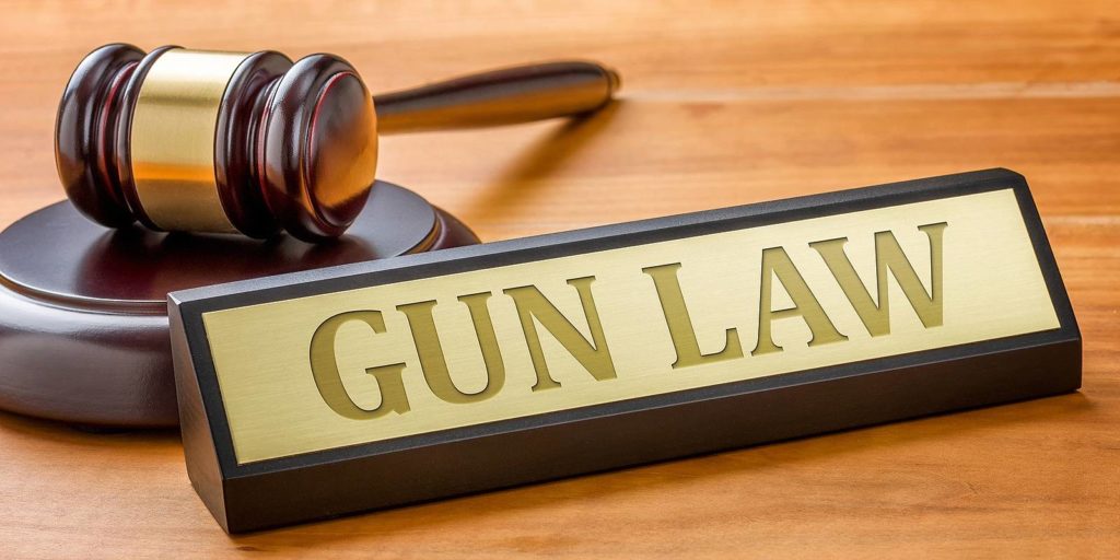 A gavel and a name plate with the engraving Gun Law. Virginia Gun Laws 2020 was recently put in place