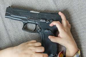 a firearm in a child's hands.Virginia Gun Laws 2020 can penalize you for leaving firearm in reach of children