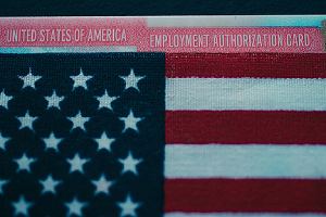 Employment authorization card under flag of USA