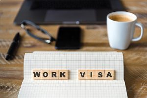 wooden blocks with letters making Work Visa