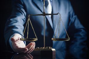 An employment law attorney and weight scale of justice. An attorney is critical in the EB-3 visa application process