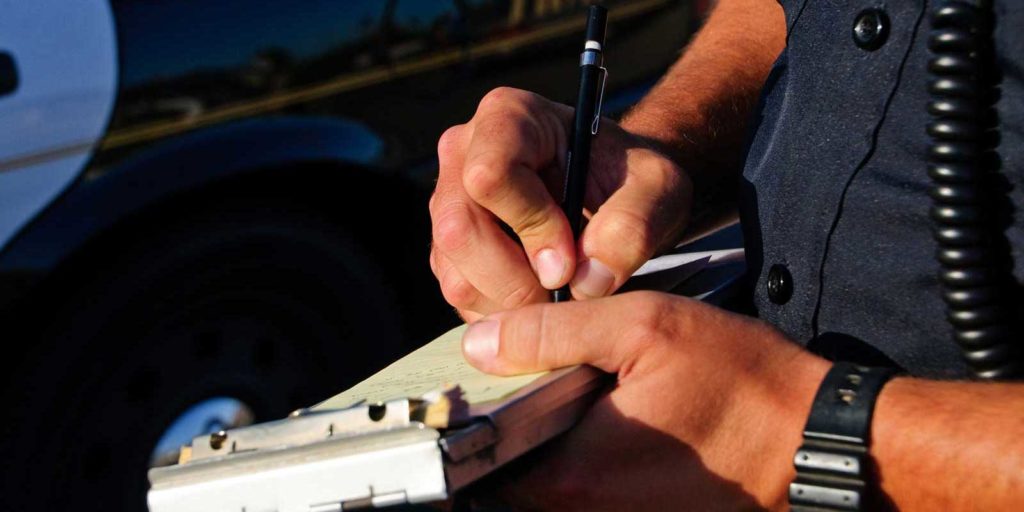 Police officer writing a reckless driving ticket in Virginia