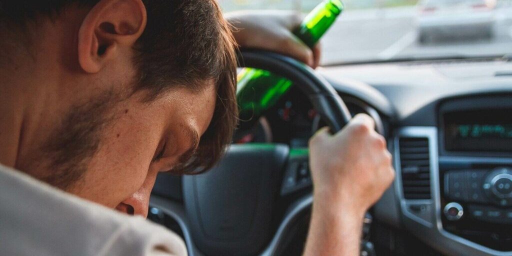 virginia dui first offense penalties drunk young man driving and sleeping in car with a bottle of beer