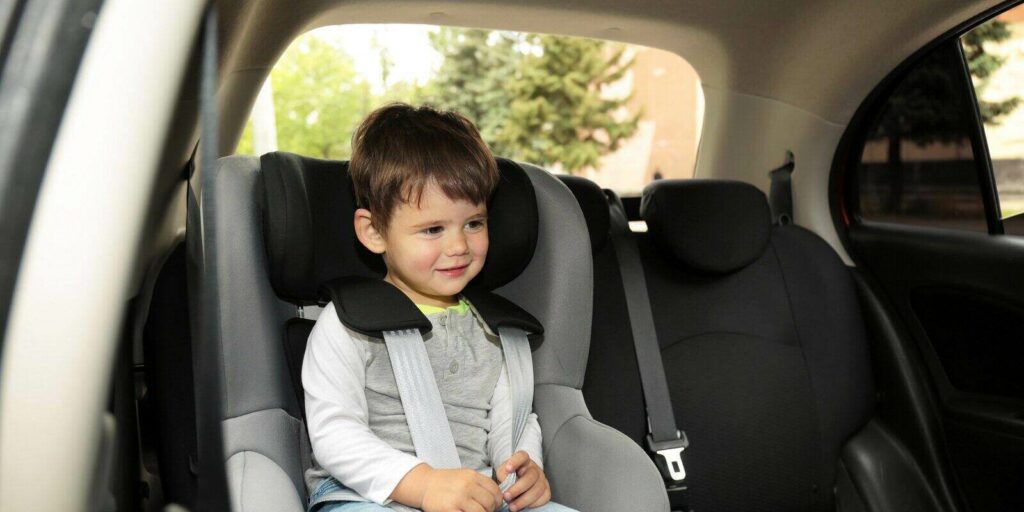 child sitting in safety seat inside car