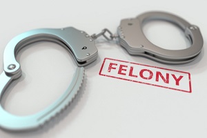 felony stamp and handcuffs