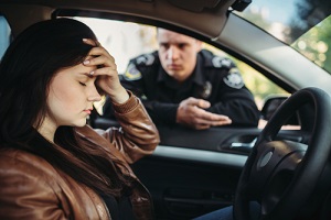 male cop in uniform check female driver on road needing a traffic defense attorney