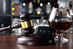 court gavel key and glass of alcohol