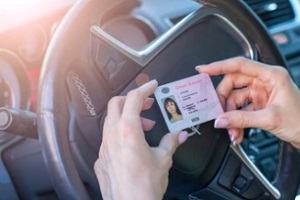 girl with driving license in the car