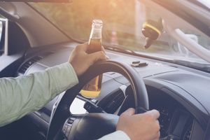 A man driving a car under the influence of alcohol
