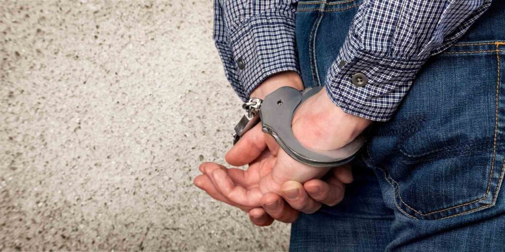 Man in handcuffs arrested for first time DUI